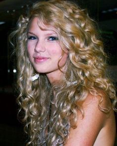 a beautiful young blond woman sitting at a table