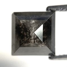 a black diamond with an arrow in the center