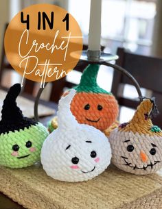 four crocheted pumpkins sitting on top of a table