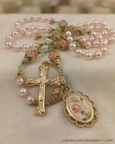 the rosary is adorned with pearls and flowers