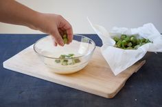 a person is dipping something into a bowl