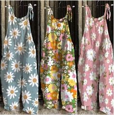 three different types of clothing hanging on a clothes line with flowers and daisies all over them