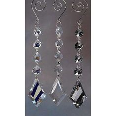 three pairs of crystal earrings hanging from hooks