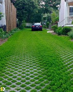 a car is parked on the grass in front of some houses