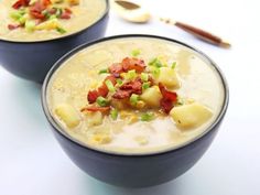 two bowls filled with soup on top of a table