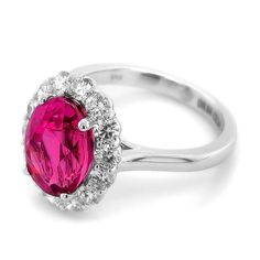 Immerse yourself in the beauty of this exquisite ring featuring a vivid pink sapphire from Madagascar, elegantly set in 18K white gold. Enhanced by sparkling diamonds, this piece is a perfect blend of luxury and timeless elegance.  Ring Overview: Center Stone: 5.34 carats of natural purplish pink sapphire, renowned for its vivid and captivating hue. Shape: Oval, offering a classic and elegant silhouette. Dimensions: 11.13 x 8.30 x 6.68 mm, highlighting the sapphire's impressive size and brillian Formal Pink Diamond Ring In Platinum, Formal Pink Sapphire Ring In Platinum, Pink Diamond Ring With Halo Setting For Formal Occasions, Pink Diamond Ring With Halo Setting For Formal Events, Elegant Pink Diamond Ring In Platinum, Fine Jewelry Pink Diamond Ring In Platinum, Formal Pink Sapphire Diamond Ring With Halo Setting, Pink Halo Ring With Prong Setting For Formal Occasions, Formal Pink Halo Ring With Prong Setting