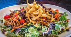 a white plate topped with salad and chips