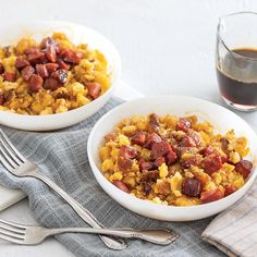 two white bowls filled with food on top of a table