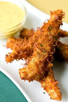 fried fish sticks with dipping sauce on the side