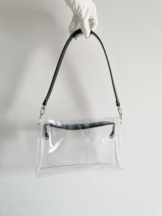 "Clear jelly baguette, transparent handbag, y2k barbiecore, kpop aesthetic, minimal style, concert bag, stadium approved, fashion purse Dimensions: 27 x 15 x 6 cm / 10, 63 x 6 x 2,36 inches Handle 60 cm / 24 inches The unique design allows you to change the character of the bag depending on your styling. Vinyl from which our treasures are made up to 60% comes from PET bottles, it has no blue color like most transparent bags on the market, it is vegan and easy to keep clean. Colors may vary a bit from screen to screen. For any questions please mail me I'll be happy to help you with informations about available sizes and colors ! I'm open for custom orders! I'm very grateful for the purchases and support of my small company during this difficult time <3 Look at another bags of my project: ww Clear Shoulder Bag With Clear Strap For Everyday, Everyday Clear Shoulder Bag With Clear Strap, Trendy Plastic Shoulder Bag With Clear Strap, Trendy Clear Shoulder Bag For Everyday, Trendy Handheld Shoulder Bag With Clear Strap, Y2k Rectangular Baguette Bag For Everyday, Everyday Use Y2k Rectangular Baguette Bag, Rectangular Y2k Baguette Bag, Trendy Shoulder Bag With Transparent Straps For Daily Use