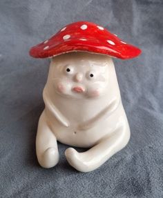 a ceramic figurine with a red hat on it