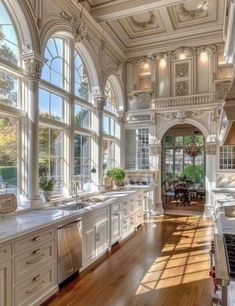 a large kitchen with lots of windows and white cabinets