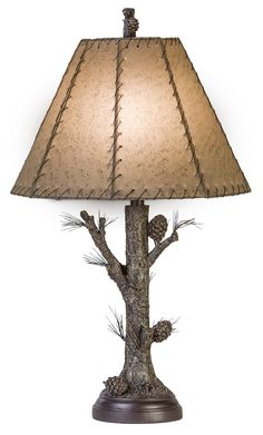 a lamp that is sitting on top of a wooden base with a light shade over it