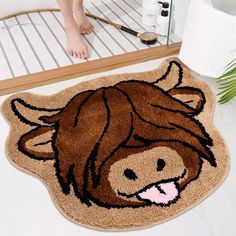 a bathroom rug with a brown cow on it and a person standing in the background