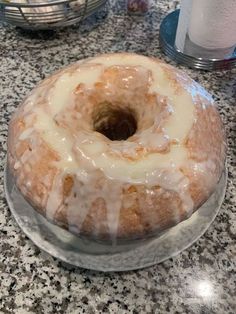 a glazed donut sitting on top of a glass plate