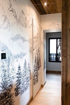 the hallway is decorated with wallpaper and wood paneling