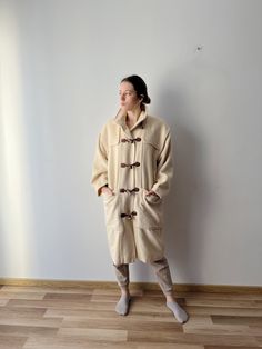 "Vintage soft wool women's coat Duffle Parka Coat Light champagne Coat 90s office lady winter wool Coat Comfortable Duffle Coat with large pockets Size Estimated size: L The medium size will be oversize                      Measurements (lying flat): Length  41.5\"/ 105.5 cm Sleeve   21.\"/ 53.3 cm Shoulder   21\"/ 53.3 cm Waist: 24\"/ 61 cm Pit to pit: 23\"/ 58.5 cm Models size:  height: 5'8\" / 174 cm Shoulders: 16\" / 40.5 cm Bust: 33.5\" / 85.5 cm  Waist: 24.5\" / 62 cm Hips: 35.5\" / 90 cm Condition: great Vintage Condition  Label: Made in Italy Please check measurements to insure a proper fit. Remember to allow yourself some extra room for movement. You can compare these with something from your closet that fits you well. This coat will come to you freshly laundered and ready to wear 90s Office, Wool Winter Coat, Duffle Coat, Vintage Soft, Parka Coat, Winter Coats Women, Office Lady, Soft Wool, Office Ladies