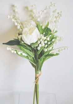 a bouquet of white flowers in a glass vase