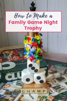 a family game night trophy made out of toilet paper rolls and dices with the words how to make a family game night trophy