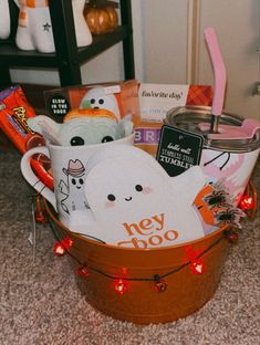 a basket filled with halloween items on top of a carpet