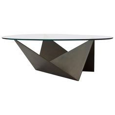 a glass and metal table with an abstract design