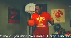 a man in a red shirt is holding a basketball ball and standing next to a hoop