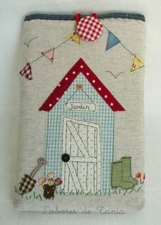 this is an image of a handmade ipad case with a little house on it