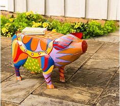 a colorful pig statue sitting on top of a patio