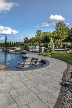 a patio with chairs and a pool in the background