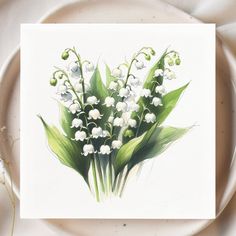 a white plate topped with a bouquet of lily of the valley flowers next to a fork and knife