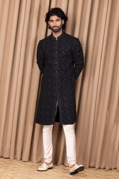 Black straight kurta with floral jaal embroidery on the front and sleeves. Comes with an ivory churidar.
Component: 2
Pattern: Embroidered
Type Of Work: Floral Jaal Patterns
Neckline: Mandarin Collar
Sleeve Type: Straight Long
Fabric: Cotton and Silk
Color: Green
Other Details: 
Front button down
Note: Pant worn by the model is not for sale
Occasion: Mehendi and Puja - Aza Fashions Semi-stitched Chikankari Kurta For Reception, Long Sleeve Jamawar Kurta With Mirror Work, Formal Churidar With Chikankari Embroidery In Chanderi, Unstitched Long Sleeve Suit With Zari Work For Reception, Long Sleeve Unstitched Suit With Zari Work For Reception, Embroidered Long Sleeve Churidar For Reception, Formal Chikankari Embroidery Churidar In Chanderi, Semi-stitched Bandhgala With Chikankari Embroidery In Straight Kurta Style, Semi-stitched Bandhgala With Chikankari Embroidery And Straight Kurta