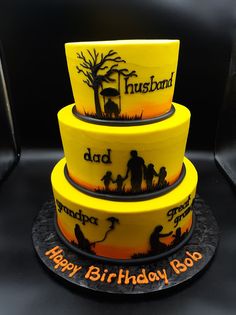 three tiered birthday cake decorated with yellow frosting and black fondant, depicting family silhouettes