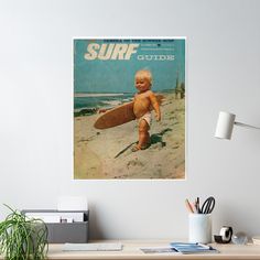 an old surf magazine cover with a baby holding a surfboard on the beach poster