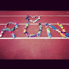 the word love spelled out on a tennis court with string attached to it's sides