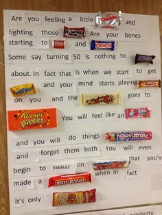 a bulletin board with candy bars attached to it's sides and words written on them