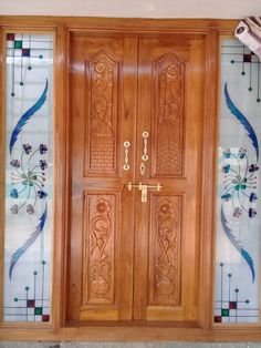 a wooden door with decorative glass on it