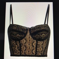 Alluring Bustier Top With A Contrast Nude Lining. Sweetheart Neckline. Lace Trim. Underwire At Cups. Corset Boning Under Bust, Torso, And Sides. Adjustable Straps. Hook Closures At Back. Lined. In Black/Nude. Fabric: 88% Nylon, 12% Spandex Lining: 85% Nylon, 15% Spandex Hand Wash Cold, Do Not Bleach Imported Lace Corset With Sweetheart Neckline And Built-in Bra, Club Corset With Built-in Bra And Sweetheart Neckline, Black Corset With Built-in Bra And Tank Straps, Black Corset With Built-in Bra And Sweetheart Neckline, Jonathan Simkhai Top, Pink Bralette, Triangle Bralette, Bralette Crop Top, Crop Top Bra