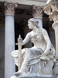 an image of a statue that is in front of a building with columns and pillars