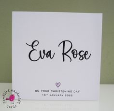 a white card with the words eva rose on it and a pink bird sitting next to it