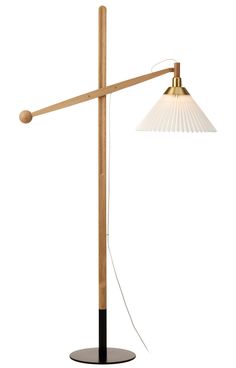 a lamp that is on top of a wooden pole and has a light bulb attached to it