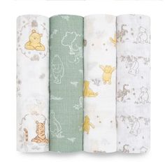 four baby swaddles with winnie the pooh characters on them, all lined up