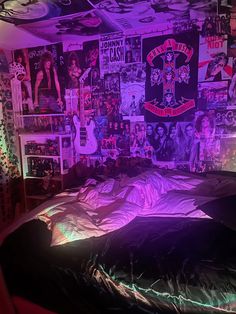 a bedroom with purple lighting and posters on the wall