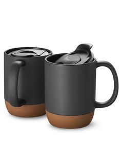 two coffee mugs sitting next to each other