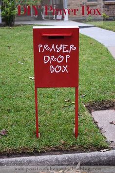 a red mailbox with the word prayer box written on it