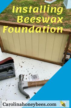 an old beewax is sitting on the ground next to tools and some grass