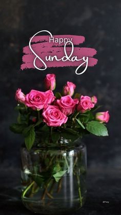 a vase filled with pink roses sitting on top of a table next to a sign that says happy sunday