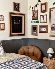 a bedroom with pictures on the wall and a bed