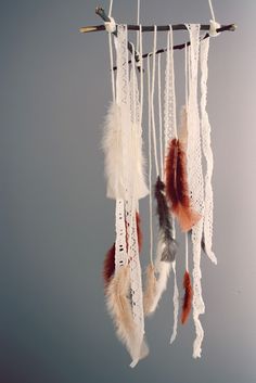 a mobile phone with an image of feathers hanging from it