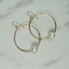 "Gold Hoop Pearl Earrings~ These elegant gold hoop earrings with a freshwater white pearl will look great for any occasion. Hammered and polished to a beautiful shine. Hoops are approx. 1.5\" Model wearing similar design~ https://www.etsy.com/listing/111095394/white-pearl-earrings-gold-hammered-hoops?ref=shop_home_active_22 Shop~ http://www.etsy.com/shop/HanaMauiCreations?ref=pr_shop_more International buyers please read our shipping policies before ordering~ POLICIES~ https://www.etsy.com/shop/HanaMauiCreations/policy?ref=shopinfo_policies_leftnav" Gold Hoop Earrings With Pearl Chain For Wedding, Wedding Gold Hoop Earrings With Pearl Chain, Gold Hoop Pearl Earrings Nickel Free, White Small Hoop Earrings For Anniversary, White Hoop Jewelry For Anniversary, White Small Hoop Jewelry For Anniversary, Gold Hoop Bridal Earrings With Pearl Drop, Akoya Pearl Drop Earrings With Ear Wire, Round Pearl Drop Jewelry