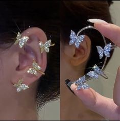 the woman is holding up her ear with two butterflies attached to it, and another piece of jewelry in front of her ear